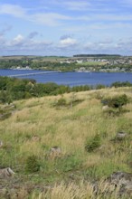 View over the Möhnesee, Körbecke village with the lake park and the lakeside promenade, blue cloudy
