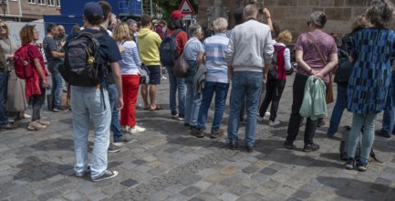 Interested tourists listen to a music group in the pedestrian zone, Nuremberg, Middle Franconia,