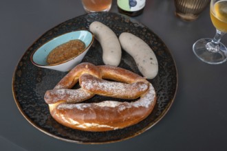 Plate with white sausages, sweet mustard and a pretzel, Franconia, Bavaria, Germany