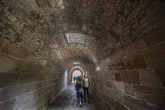 Tourists walk through the historic entrance to the Imperial Castle, Nuremberg, Middle Franconia,