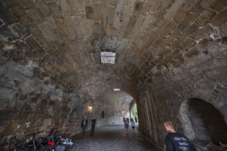 Tourists walk through the historic entrance to the Imperial Castle, Nuremberg, Middle Franconia,