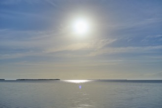 The sun shines over a calm sea under a blue sky, Flamingo, Everglades National Park, Florida, USA