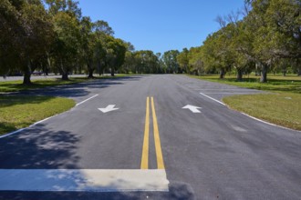 An empty car park with lane markings surrounded by trees, Flamingo, Everglades National Park,