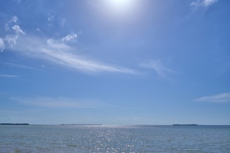 Sparkling water under a clear blue sky with the sun high above, Flamingo, Everglades National Park,