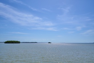 Islands on a calm sea under a light blue sky with light clouds, Flamingo, Everglades National Park,