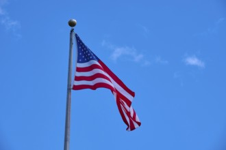 American flag waving against the clear, cloudy sky, Flamingo, Everglades National Park, Florida,