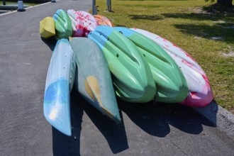 Stack of colourful kayaks on a paved surface, Flamingo, Marina, Everglades National Park, Florida,