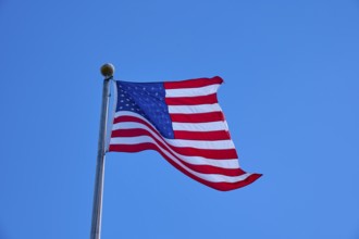 American flag flies majestically in front of a slightly cloudy sky, Flamingo, Everglades National