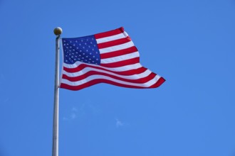 Stars and Stripes waving on a pole under a clear sky, Flamingo, Everglades National Park, Florida,