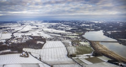 Aerial view of Möhnesee in winter with snow and view of Körbecke in Möhnesee in Sauerland in North