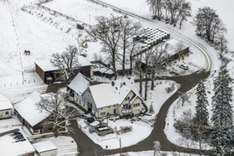 Aerial view of the winter landscape in Mosebolle with riding stable near Meschede in winter with