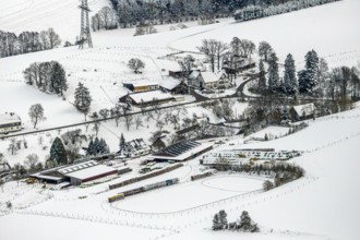 Aerial view of the winter landscape in Mosebolle with riding stable near Meschede in winter with