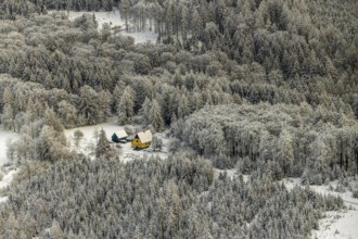 Aerial view of the Meschede forest near Enste with a country house in Meschede in winter with snow