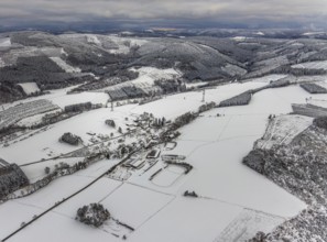 Aerial view of the winter landscape in Mosebolle with riding stable near Meschede in winter with