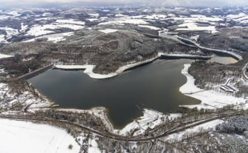 Aerial view of the Hennesee at low water near Meschede in winter with snow in the Sauerland in