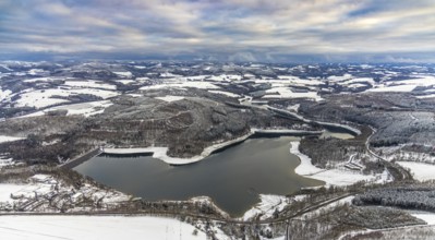 Aerial view of the Hennesee at low water near Meschede in winter with snow in the Sauerland in