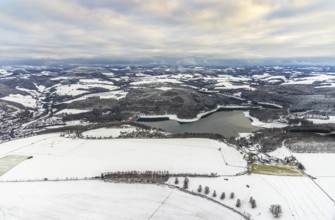 Aerial view of the Hennesee at low water near Meschede in winter with snow in the Sauerland in