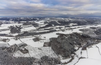 Aerial view of the winter landscape in Mosebolle with riding stable near Meschede in winter with