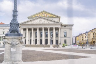 An impressive building with columns in the centre of Munich under a cloudy sky, Munich, Germany