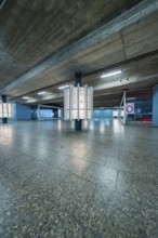 Concrete subway with blue walls and modern lighting, creates an industrial atmosphere, Munich,