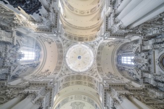 An impressive baroque ceiling with dome and ornamental decorations in a church, Munich, Germany