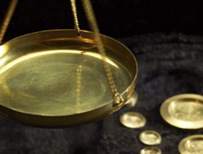 Detail of historic scales with metallic weights in dark back