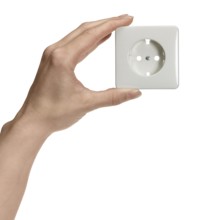 Feminine hand holding a white socket in front of white back