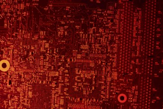 Full frame red illuminated printed circuit board closeup
