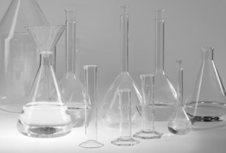 Variety of partly filled laboratory glassware