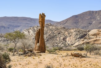Sunny illuminated landscape including a rock formation seen in Namibia