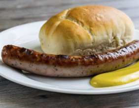 Fried sausage with mustard and a bread roll on a plate (AI generated)