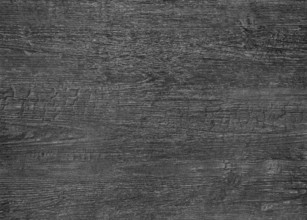 A full frame dark burnt wood grain surface