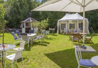 Sunny illuminated idyllic scenery showing a garden prepared for party