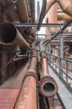 Weathered rusty industrial scenery with old corroded steel girders and metal tubes