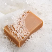 AI generated closeup image showing a soap bar and foam