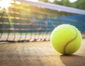 AI generated image showing a tennis ball closeup in sunny court ambiance