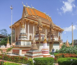 Sunny illuminated scenery around a rich ornamented temple in Cambodia