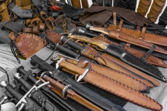 Some daggers and other equipment seen at a medieval market