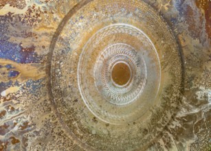 Full frame abstract closeup shot of a colorful metallic asian gong