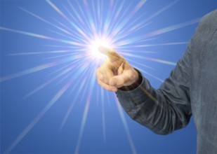 Pointing male hand with starlight in blue back