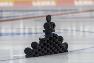Symbolic picture DEL (German Ice Hockey League) : Close-up of pucks stacked on the ice for play-in