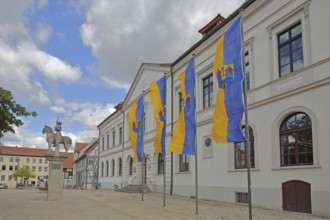Town flags on the town hall with Roland statue, equestrian statue, equestrian statue, market