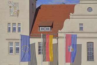 Renaissance town hall with EU flag, German national flag and town flag, three, flags, Coswig,