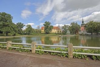 Castle and pavilion at the spa park pond with church tower of the town church, Goethe School,