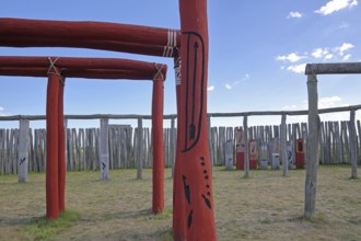 Archaeological reconstructed circular ditch from the Stone Age, Bronze Age, poles with runes, bow
