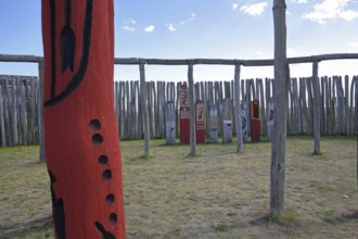 Archaeological reconstructed circular ditch from the Stone Age, Bronze Age, poles with runes, bow