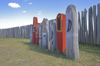 Archaeological reconstructed circular ditch from the Stone Age, Bronze Age, poles with runes, bow