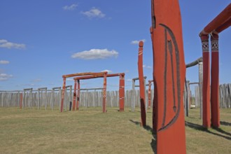 Archaeological reconstructed circular ditch from the Stone Age, Bronze Age, poles with runes, bow