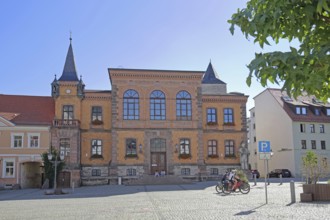 Town hall built in 1876, cyclist, market square, Calbe, Saxony-Anhalt, Germany