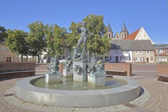 Market fountain by Frank Sobirey on the history of the town, nude female figure and putti, modern